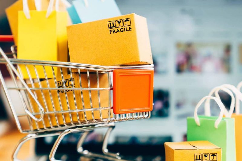 Shopping cart full of colorful bags