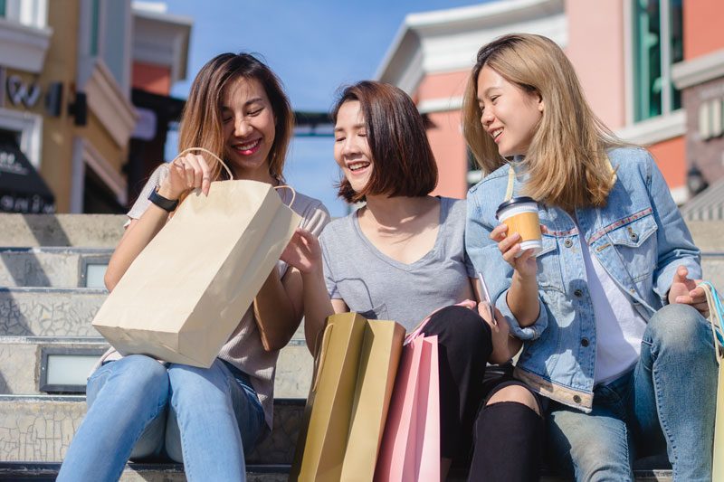 Friends heading home with shopping bags