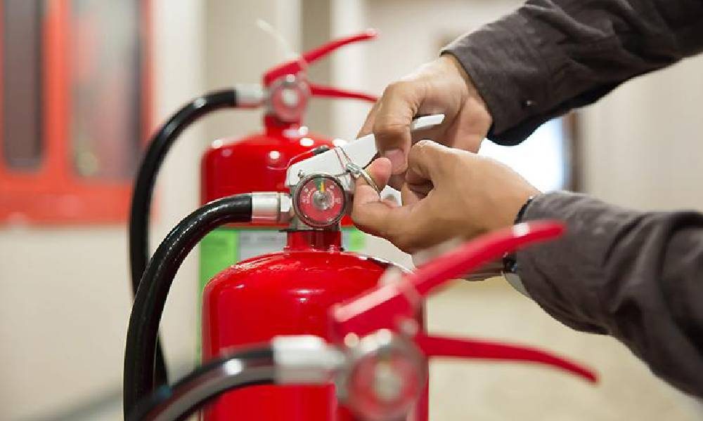 Person checking a fire extinguisher