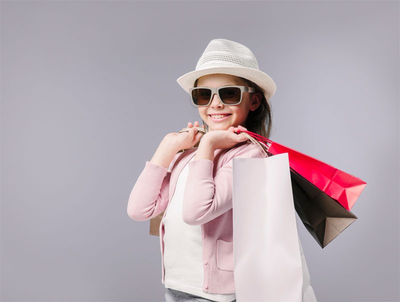 Smiling shopper holding shopping bags